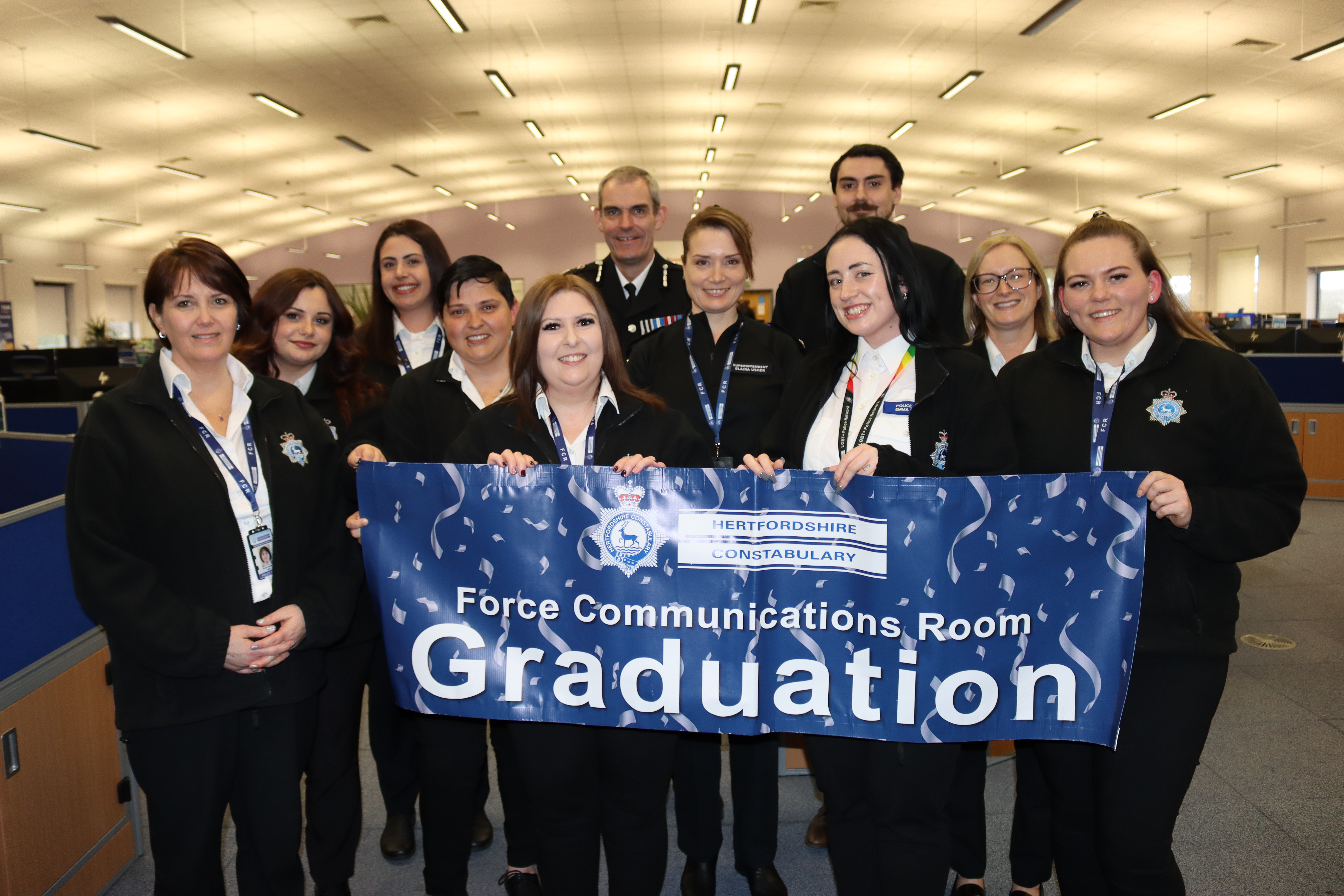 A photo of Chief Constable Charlie Hall and Superintendent Elaina Usher with our new communications operator recruits at their graduation ceremony.
