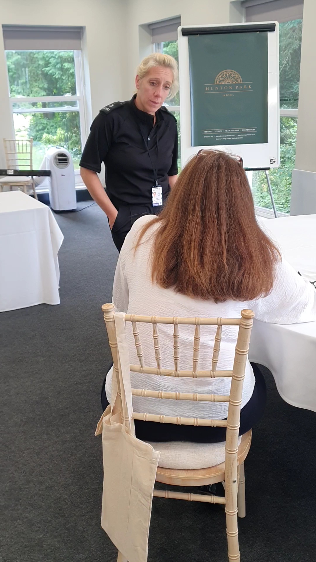 Police officer speaking to a member of hospitality staff