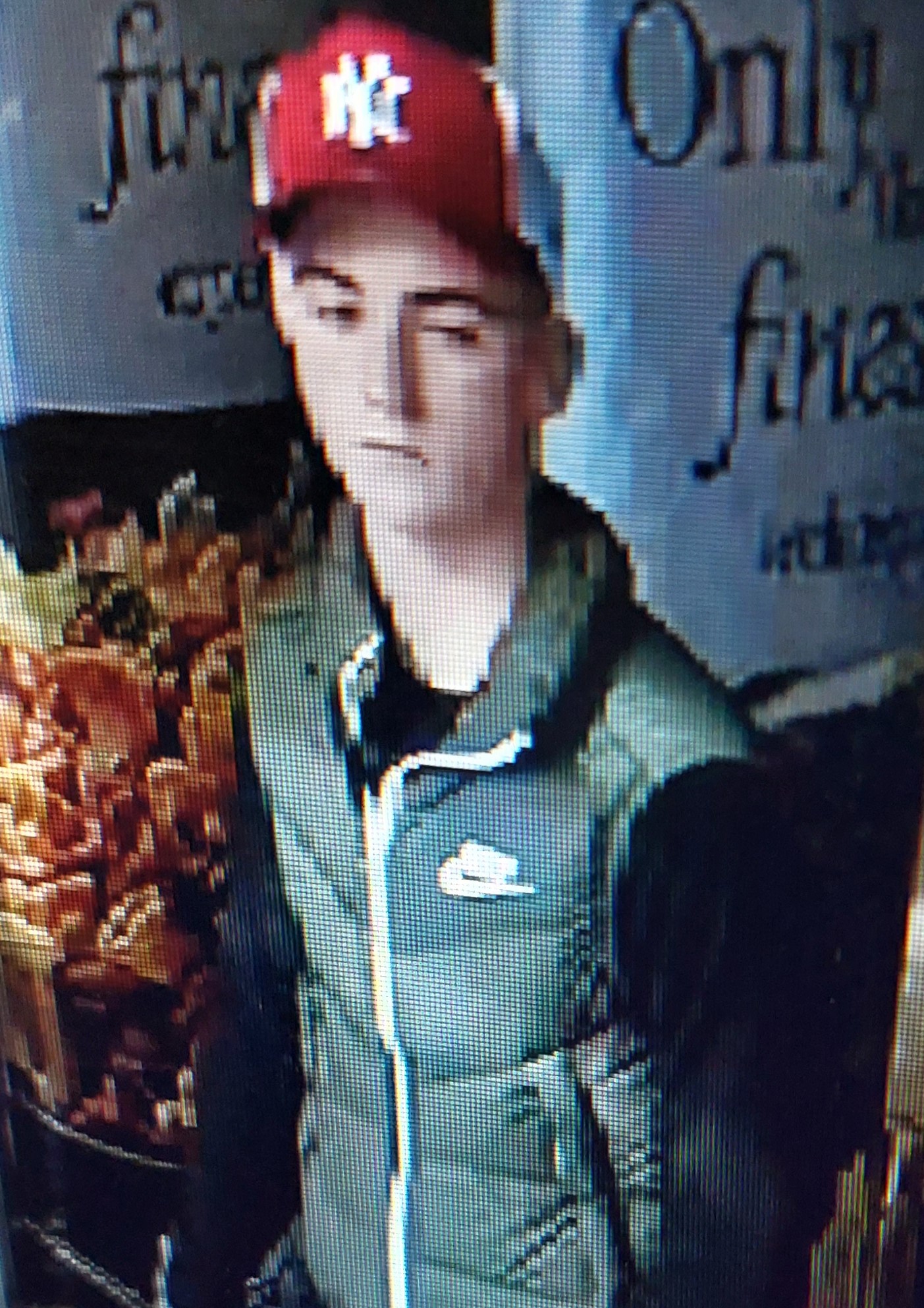 Picture of suspect wearing red cap and green coat