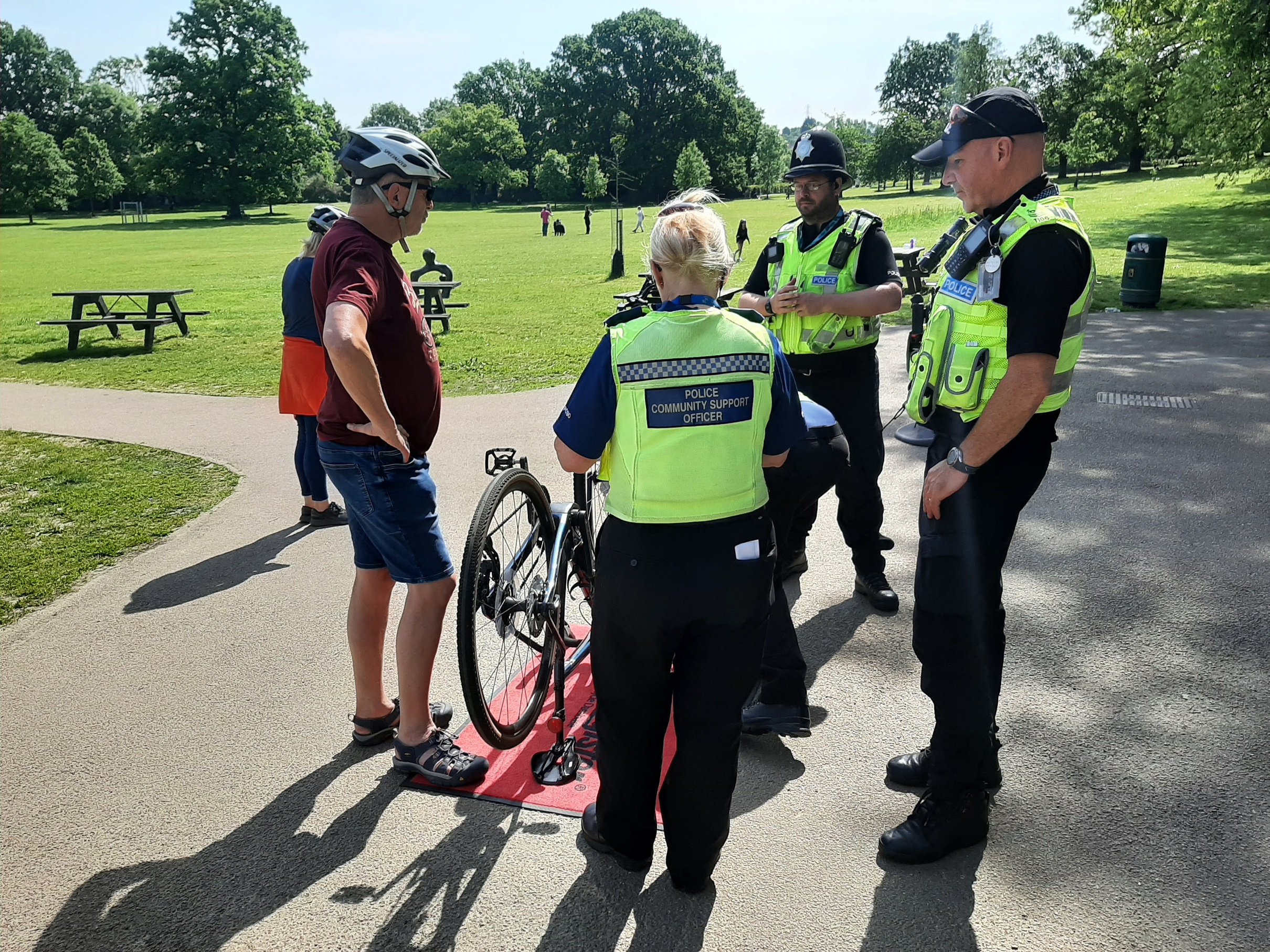 Three officers with cyclist