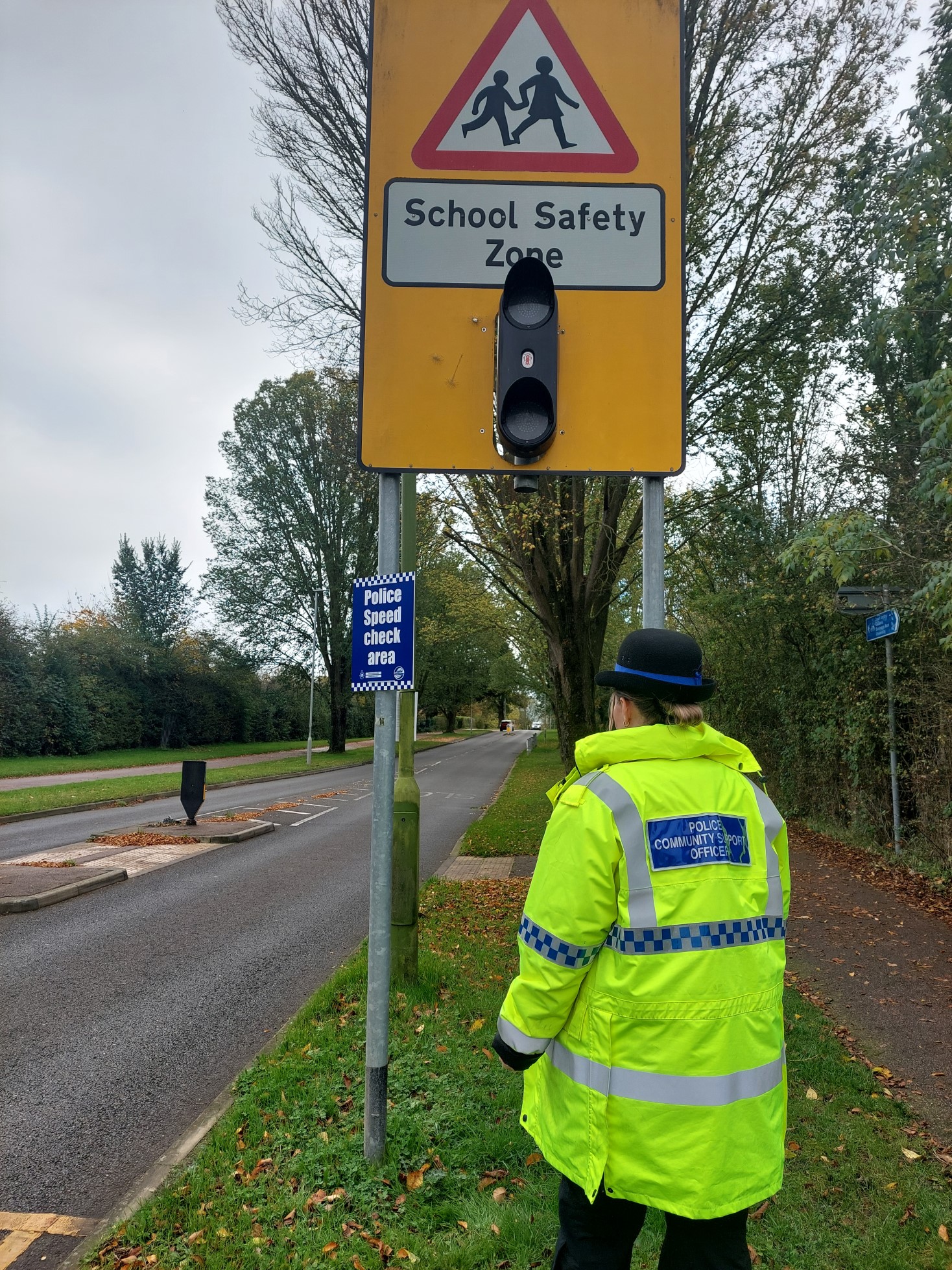 officer putting up posters 