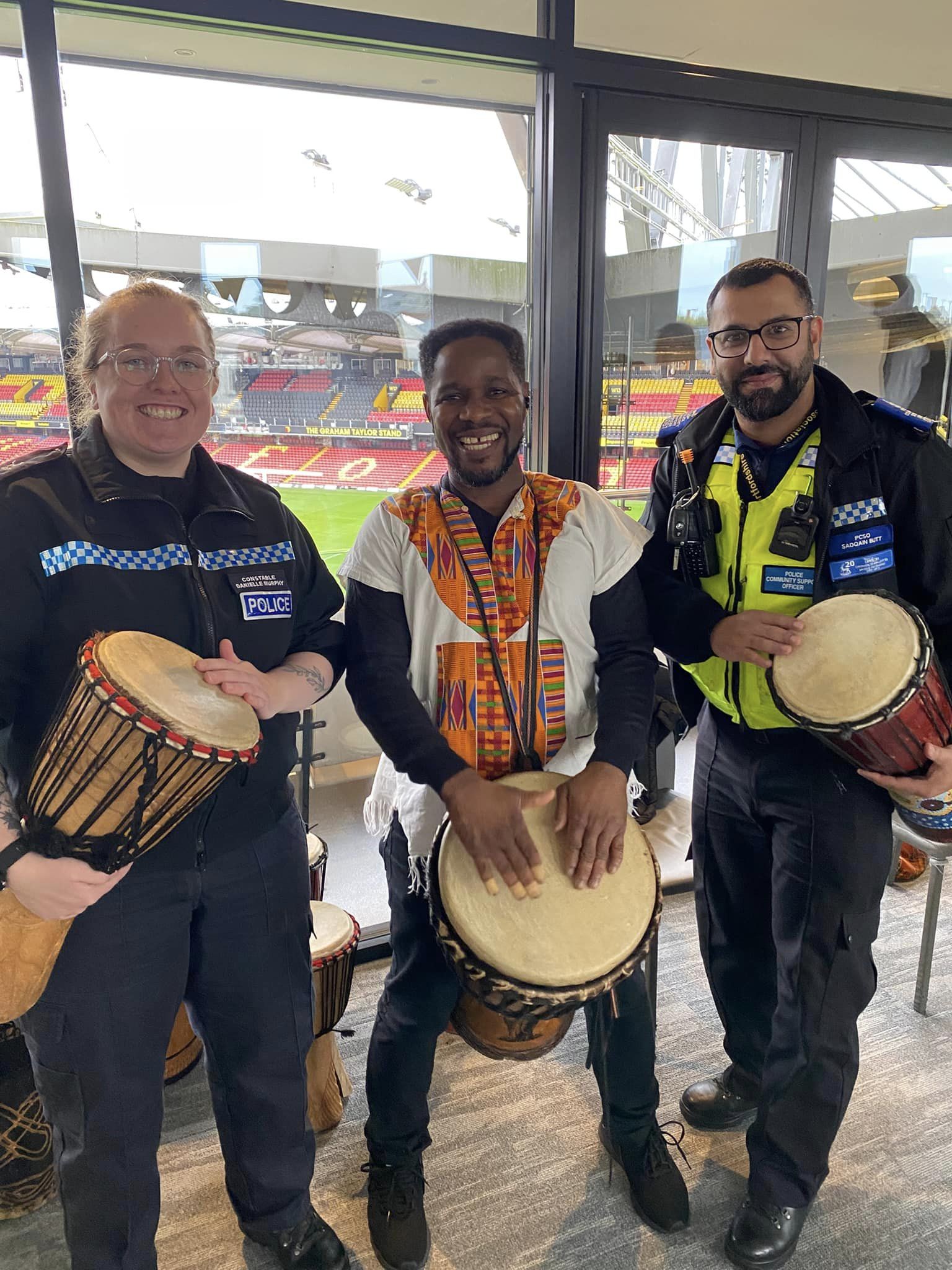 PC Danielle Murphy, Kofi from Masihi Arts and PCSO Sadqain Butt at the African drumming workshop at Watford FC.