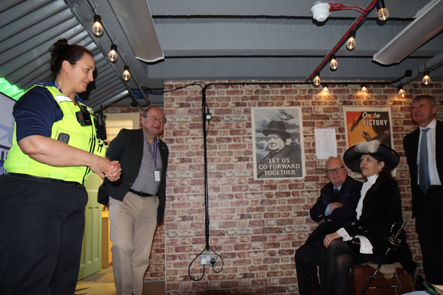 anne and alistair giving a talk in the bunker. colin and the high sheriff are seated and listening