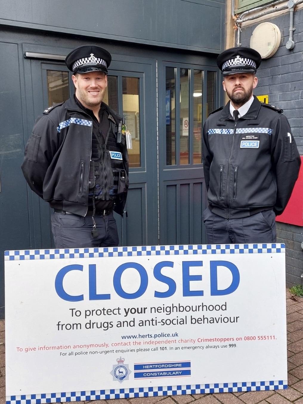 Police officers with closure board 